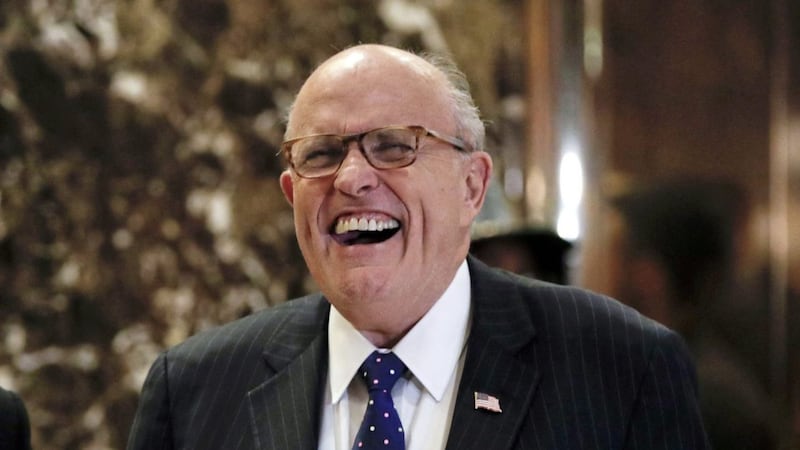 Former New York Mayor Rudy Giuliani laughs as he arrives at Trump Tower in New York on Wednesday. Picture by Carolyn Kaster, Associated Press 