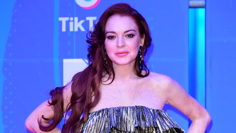 The actress, 36, shared two pictures of herself posing with younger brother Dakota Lohan in Parliament Square, opposite the Houses of Parliament.