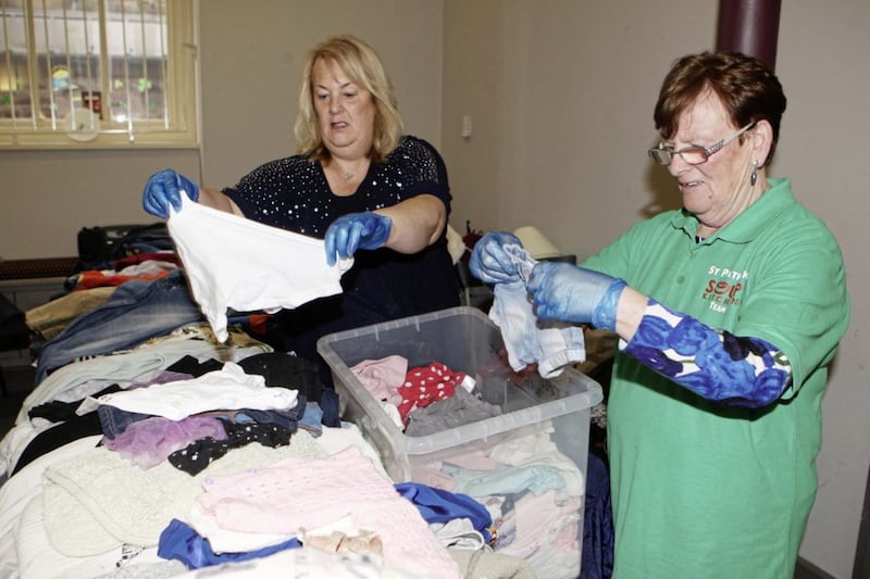 Volunteers Linda Duffy and Rosaleen Beattie sort out clothes donations at the soup kitchen. Picture Matt Bohill 