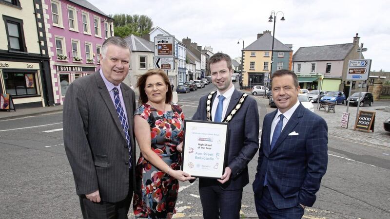 Ballycastle Chamber of Commerce president John McGill and Julienne Elliott from Causeway Coast &amp; Glens Borough Council receive the High Street of the Year accolade for Ann Street from Retail NI chief executive Glyn Roberts (right) and Irish News business editor Gary McDonald. Photo: Steven McAuley/McAuley Multimedia 