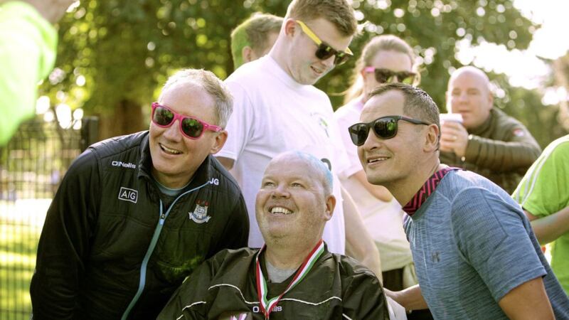 Anto Finnegan pictured with Dublin manager Jim Gavin and Jason Sherlock at the Run For Anto event in Falls Park yesterday. The proceeds of the colour run are going to deterMND Picture by Ann McManus. 