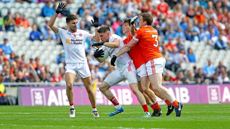Tyrone's Mattie Donnelly is tackled by Armagh duo Charlie Vernon and James Morgan Picture by Seamus Loughran