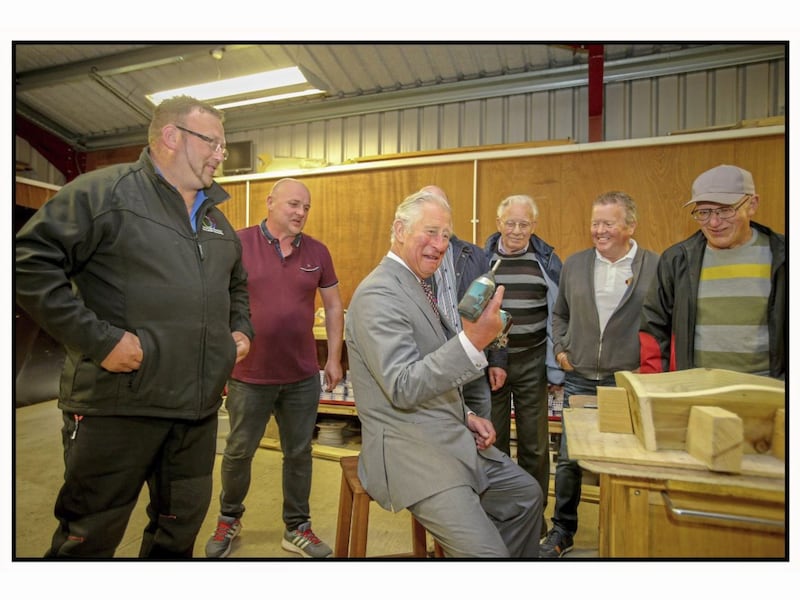 Prince Charles helped put the finishing touches to a tiny wheelbarrow being constructed by members of a Men&#39;s Shed project during his visit to Co Tyrone Picture by Mal McCann. 