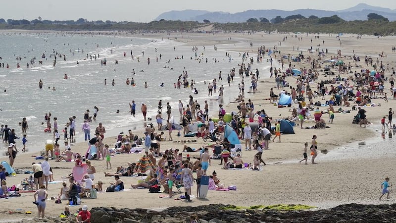 Crowds of people enjoying the sun on Portmarnock beach near Dublin (Niall Carson/PA)