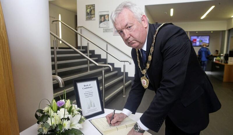 Chair of Mid Ulster Council Sean McPeake signs the book of condolence in Ranfurly House in Dungannon. Picture by Mal McCann 