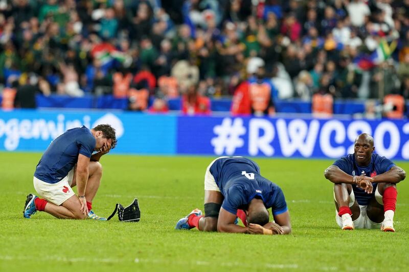France's Antoine Dupont, Cameron Woki and Sekou Macalou react after their defeat to South Africa