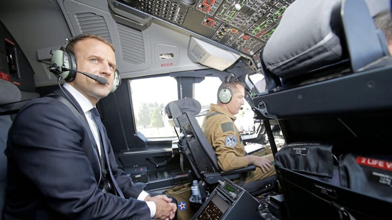 French President Emmanuel Macron is seated in the cockpit of an Airbus A400M turboprop transport plane before taking off from Villacoublay military airbase near Paris, yesterday. Mr Macron landed at the Bourget airfield in an Airbus A400-M military transport plane to launch the aviation showcase. News that Mr Macron&#39;s party took the majority of the seats in the French assembly was welcomed by traders, as it represents political stability in one of the biggest countries of the EU  PICTURE: Michel Euler/AP 