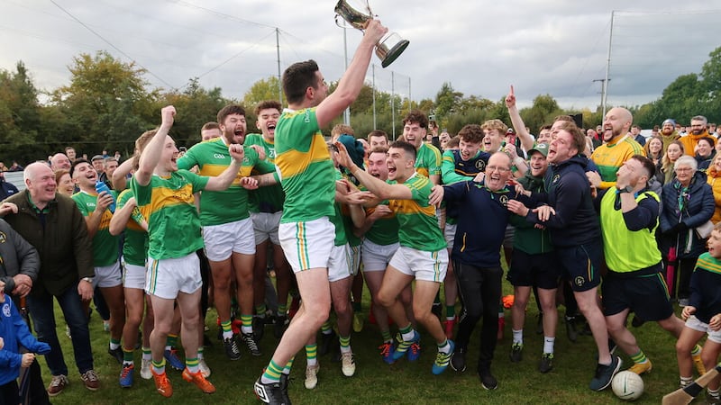 Dunloy captain Kevin McQuillan raises the intermediate championship trophy last autumn. Kevin is a brother of manager Anthony, and their father Paddy 'Murphy' McQuillan was a key figure around football in Dunloy. Picture: John McIlwaine