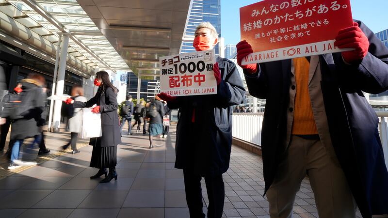 LGBTQ activists distributed chocolates to morning commuters at Shinagawa Station (AP)