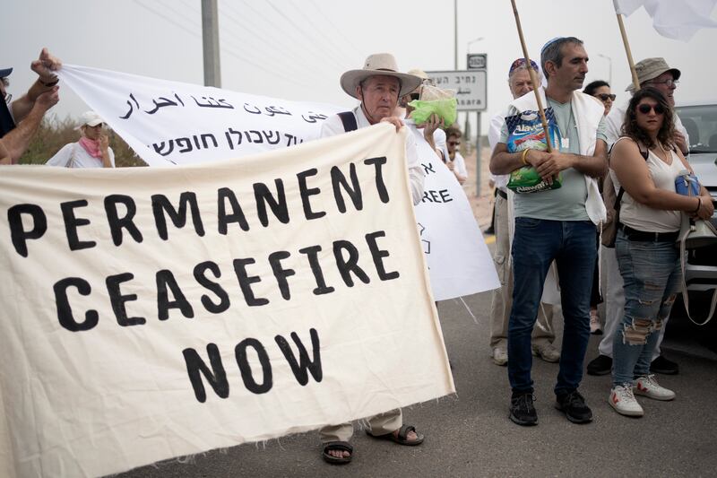 Activists and a delegation of American and Israeli rabbis from Rabbis for Ceasefire rally near the Erez crossing to the Gaza Strip (AP)