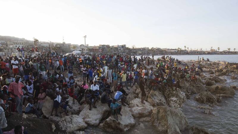 Residents wait on the shore as a boat with water and food from the Mission of Hope charity arrives after Hurricane Matthew swept through Jeremie in Haiti. Picture by Dieu Nalio Chery, Associated Press&nbsp;