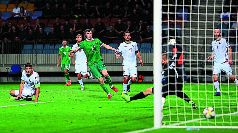 Paddy McNair slides home the winning goal in Northern Ireland's 1-0 win in Belarus
