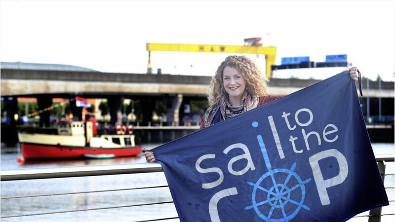 Jacinta Hamley flies the flag for climate crisis solutions at Donegall Quay in Belfast. Picture by Hugh Russell 