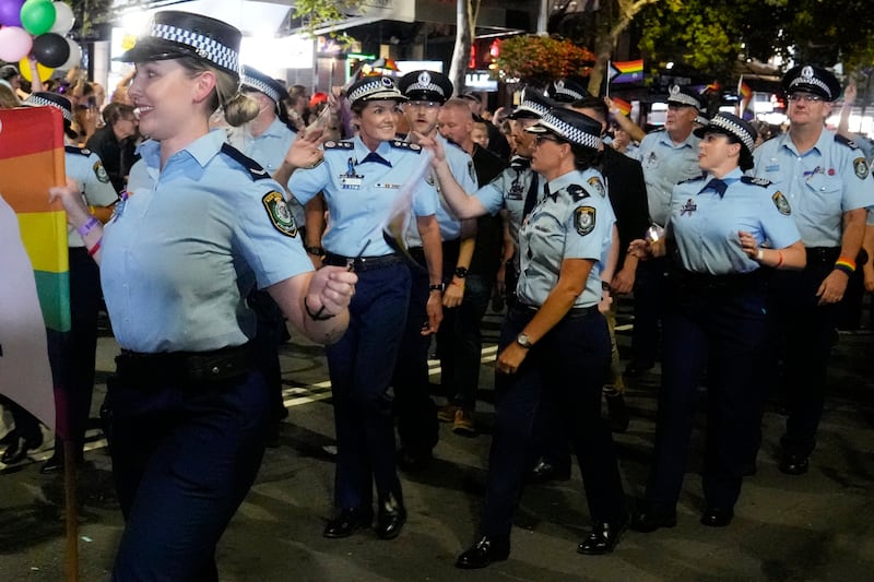 The New South Wales Police Commissioner Karen Webb, second left, waves as she marches in the 45th Anniversary Sydney Gay and Lesbian Mardi Gras Parade in 2023 (AP)