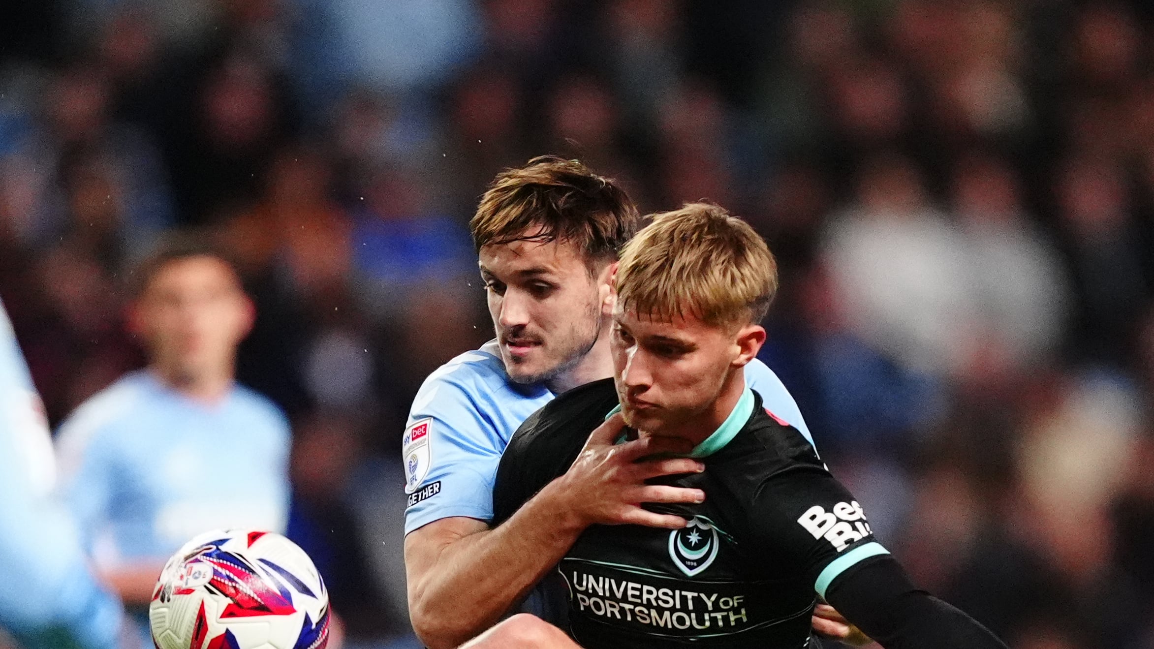Coventry City’s Liam Kitching (left) and Portsmouth’s Thomas Waddingham battle for the ball during the Sky Bet Championship match at the Coventry Building Society Arena, Coventry. Picture date: Wednesday April 9, 2025.