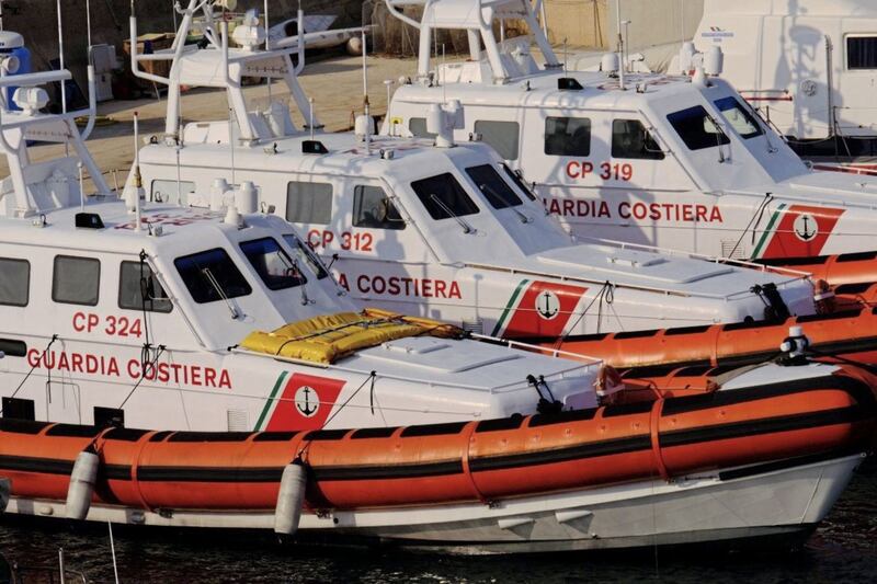 Coastguard search and rescue vessels berthed in Lampedusa harbour. Picture by Damian Jackson. 