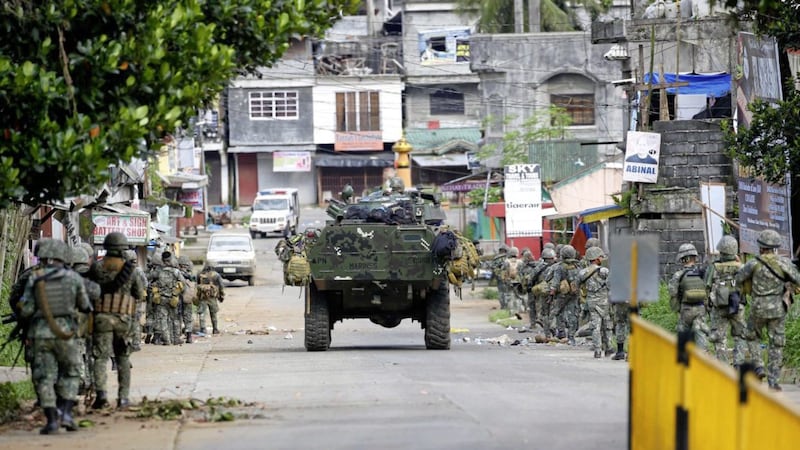 Philippine marines walk to the frontline in the continuing assaults to retake control of some areas of Marawi city Sunday, May 28, 2017 in the south of the country PICTURE: Bullit Marquez/AP 