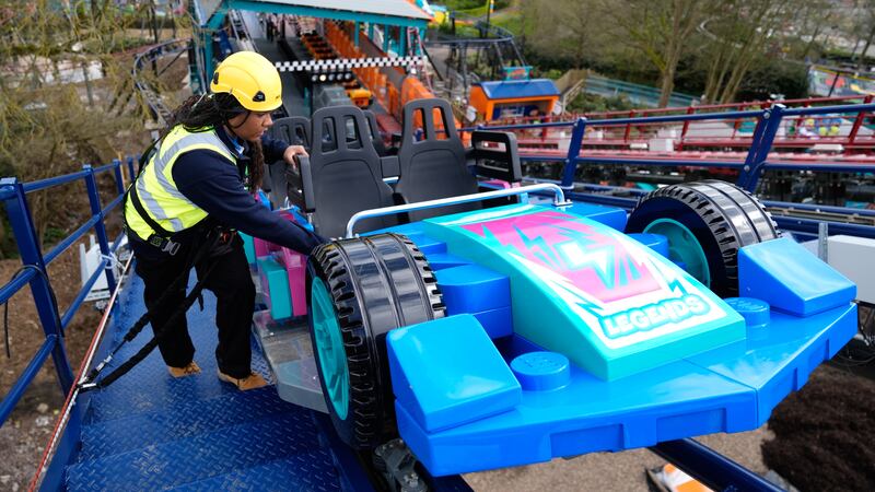 Legoland team member Shenica Gumbs inspects a car on the Minifigure Speedway, as final checks are made to the new ride at Legoland Windsor Resort, in Berkshire
