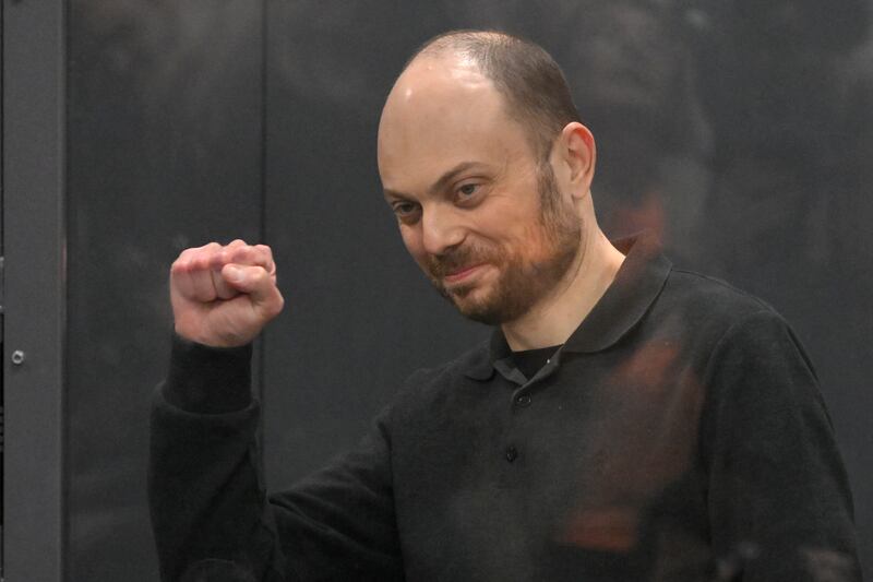 Russian opposition activist Vladimir Kara-Murza gestures standing in a glass cage in a Moscow court on July 31, 2023 (AP)