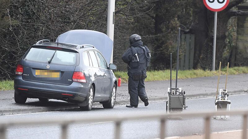 &nbsp;British Army bomb disposal experts examine the car. Picture by Hugh Russell
