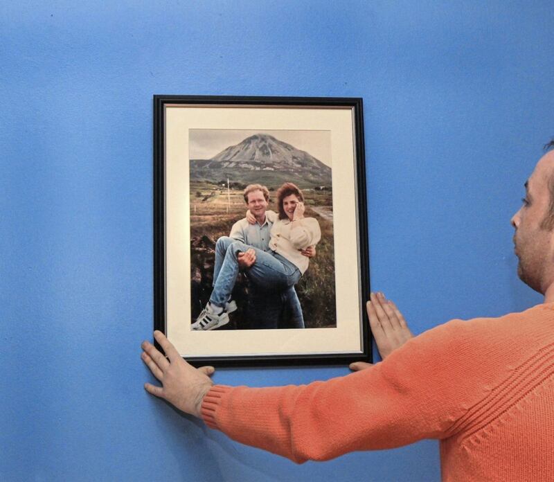 A photograph of Martin McGuinness and his wife Bernie below Mount Errigal in Donegal is put on the wall at the Gasyard Centre as part of the exhibition from the McGuinness Family Collection. Picture by Margaret McLaughlin 