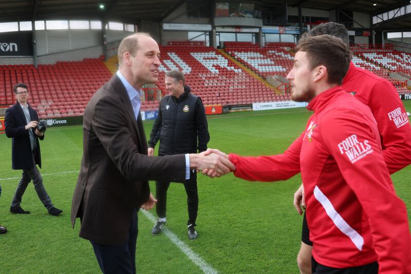 The Prince of Wales meets staff and players on the pitch at Wrexham AFC