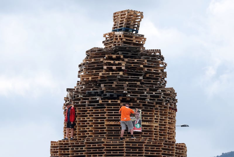 An election poster of the SDLP's Gary McKeown is placed on a bonfire in the Village area of south Belfast