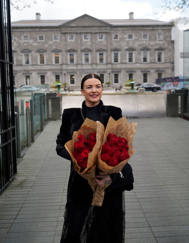 Lisa Lawlor carrying 49 roses to Leinster House, Dublin, where taoiseach Simon Harris apologised for the Irish states failures to the families of the Stardust victims
