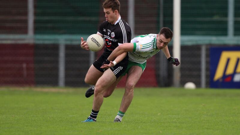 Kilcoo's Darragh O'Hanlon (left) controls the ball ahead of Burren's Ryan Treanor during the Down SFC final at Pairc Esler. Picture by Cliff Donaldson&nbsp;