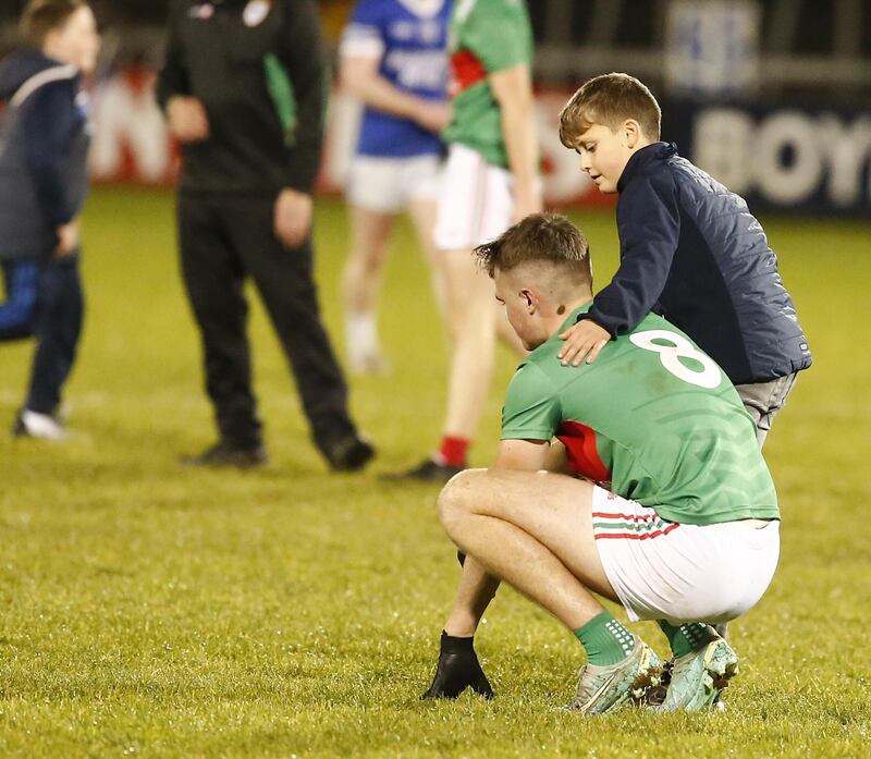 A young supporter consoles devastated Gowna player Tiernan Madden.