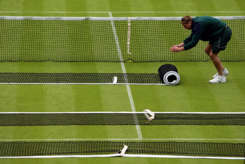 The nets are prepared on Centre Court during a practice day for the 2010 Wimbledon Championships at the All England Lawn Tennis Club, Wimbledon.