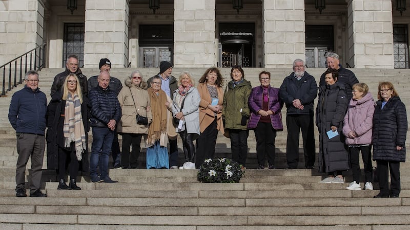 Members of the Families of the Disappeared walk from Carson's Statue to the steps of Parliament Buildings where they lay a black wreath with five white lilies representing those who have yet to be found - Joe Lynskey, Columba McVeigh, Robert Nairac, Seamus Maguire and Lisa Dorrian. Picture: Liam McBurney/PA