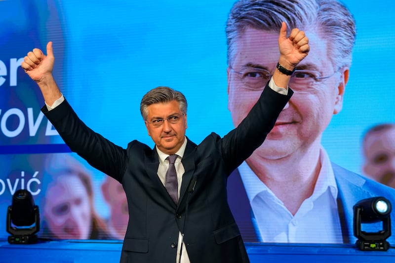 Prime Minister incumbent Andrej Plenkovic waves after claiming victory in a parliamentary election in Zagreb, Croatia, (Darko Vojinovic/AP)
