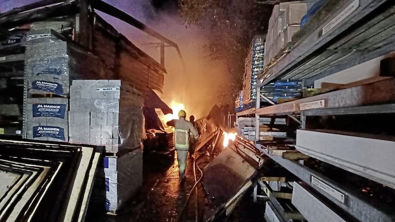 Firefighters tackle a large fire at a builder&#39;s merchants in Larne on Tuesday evening. Picture: NIFRS 