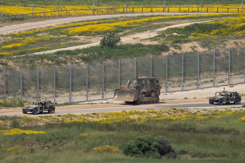 An Israeli army bulldozer is seen near the Gaza Strip border (Ohad Zwigenberg/AP)