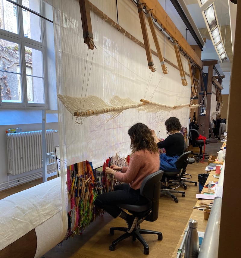 Weavers working on a tapestry at the Gobelins Manufactory 