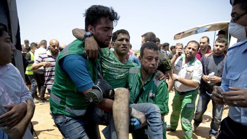 Medics assist a wounded Palestinian during a protest near Beit Lahiya, Gaza Strip, last week 