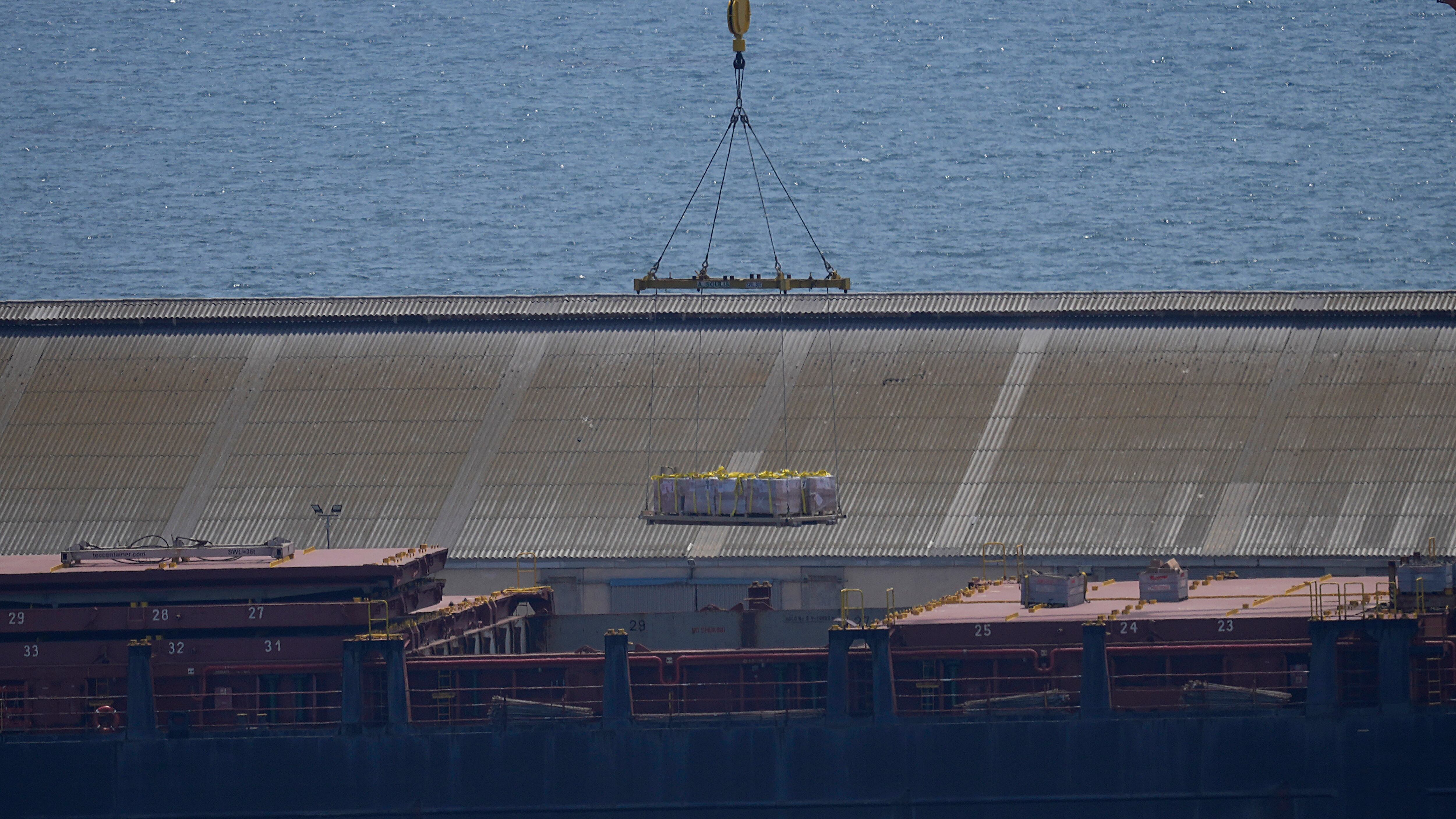 A crane loads food aid for Gaza onto the container ship Sagamore docked at Larnaca port, Cyprus (Petros Karadjias/AP)