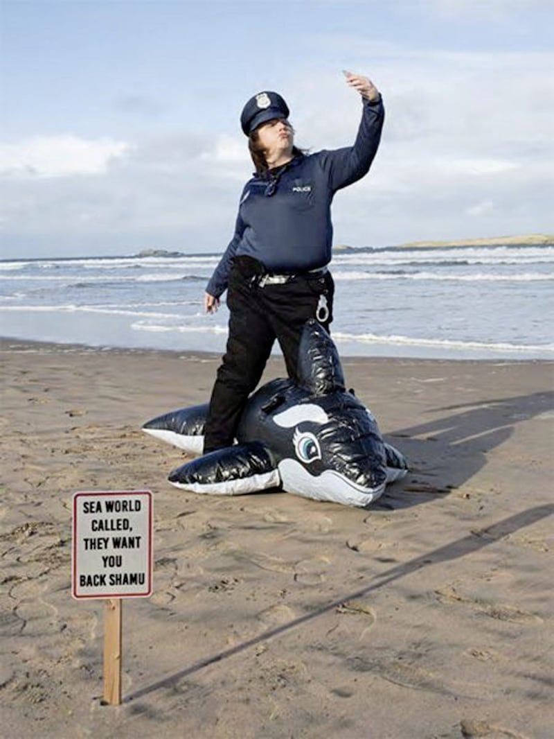 Protect and Serve &ndash; the photographer-turned-US policeman poses alongside his comment in the sand 