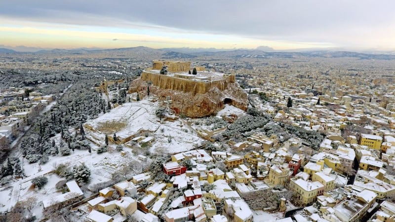 The Parthenon temple is seen atop of the snow-covered Acropolis hill in Athens. Picture by Antonis Nikolopoulos, Eurokinissi via Associated Press