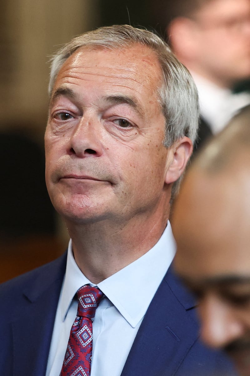Reform UK leader Nigel Farage walks through the Member’s Lobby of the Houses of Parliament in London