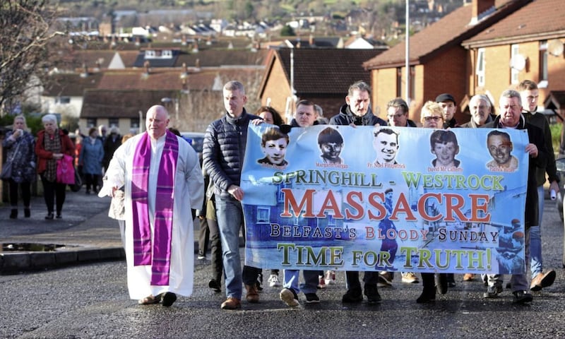 People whose loved ones died in the Springhill-Westrock Massacre in July 1972 make their way with Corpus Christi parish priest Fr Patrick McCafferty to a wreath-laying ceremony. Among those killed was Fr Noel Fitzpatrick. Picture by Pacemaker Press 