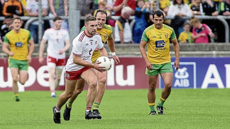 Tyrone&#39;s Niall Sludden comes under pressure from Donegal&#39;s Michael Murphy in the 2018 All-Ireland SFC quarter-final game on Sunday August 5 at Ballybofey. Picture Seamus Loughran. 
