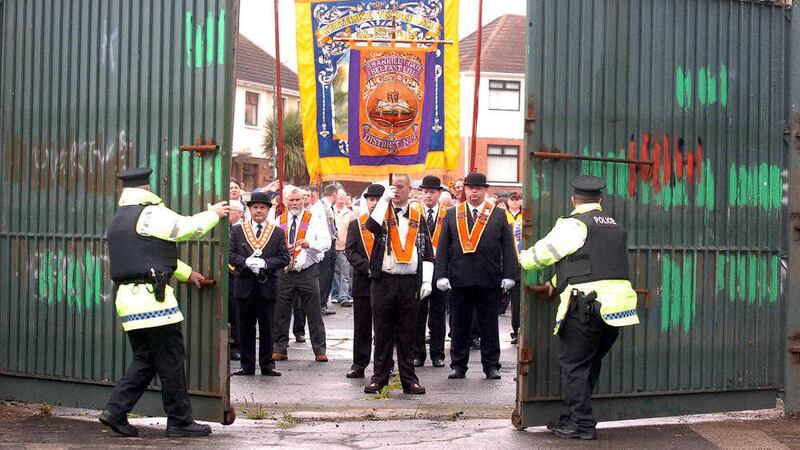 Police open the &#39;peace line&#39; gates at Workman Avenue in west Belfast, where Orangemen have now also been banned from passing nationalist homes 