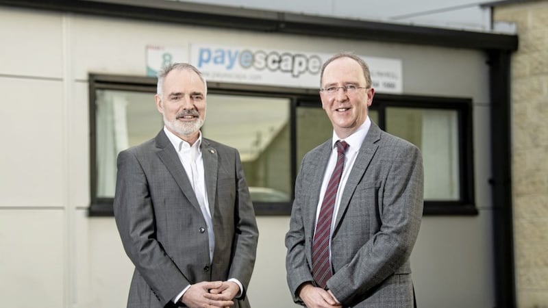 Payescape managing director John Borland (left) with Des Gartland from Invest NI during an investment announcement earlier this year 