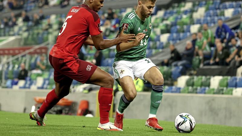 Dion Charles in action for Northern Ireland against Switzerland's Manuel Akanji during a World Cup qualifier at Windsor Park last September. Pic: Niall Carson/PA Wire 