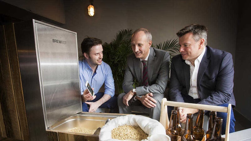 Chris McClelland from Brewbot demonstrating his technology to Ian Sheppard, Bank of Ireland and Steve Orr, NISP Connect at the publication of the 2015 Knowledge Economy Report 