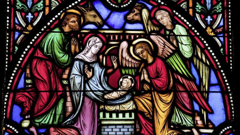 St John&#39;s Gospel describes Jesus as &#39;the light of the world&#39;. He is illuminated here in a stained glass window in St Michael and St Gudula Cathedral, Brussels depicting a nativity scene. 