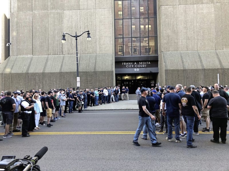 In this photo provided by WKBW, supporters of two suspended Buffalo police officers assemble outside the courthouse in Buffalo, New York on Saturday June 6. According to prosecutors, both officers were charged with assault after a video showed them shoving 75-year-old protester Martin Gugino at a demonstration over the death of George Floyd. Picture by Madison Carter/WKBW via AP 