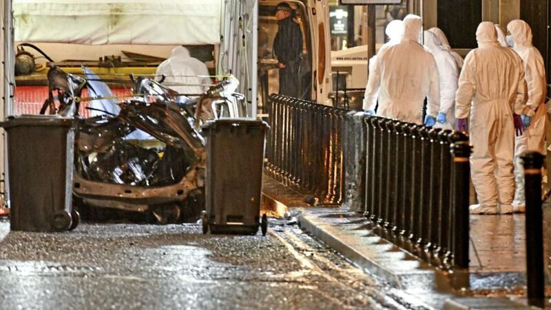 Forensics officers remove the remains of the a van outside the Courthouse in Derry following an explosion. 